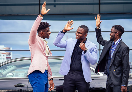 three men high-fiving
