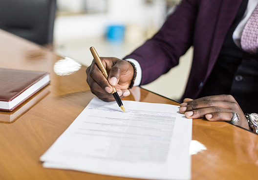 man signing a document