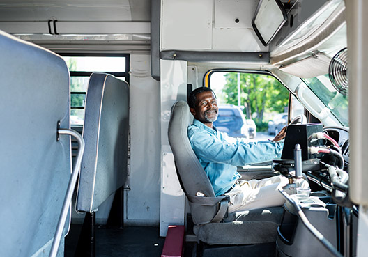 man sitting behind the wheel of a car