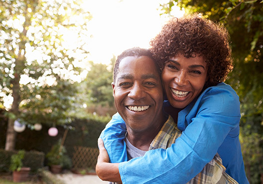 woman loving wrapping her arms around her husband