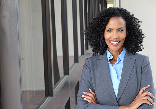 lady with her arms crossed in a business suit